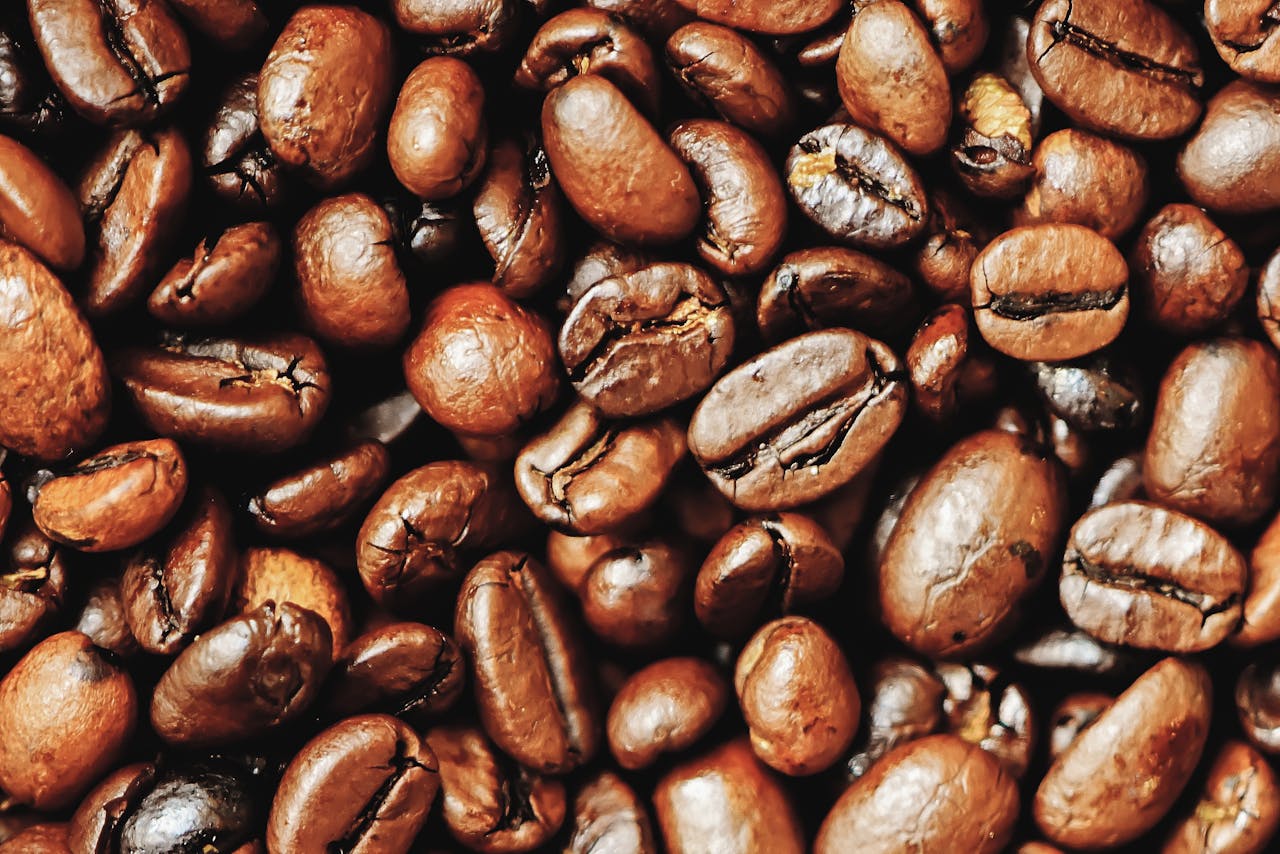 Detailed view of rich, roasted coffee beans showcasing their texture and aroma.